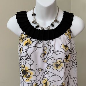 White, yellow and black floral print tank blouse.